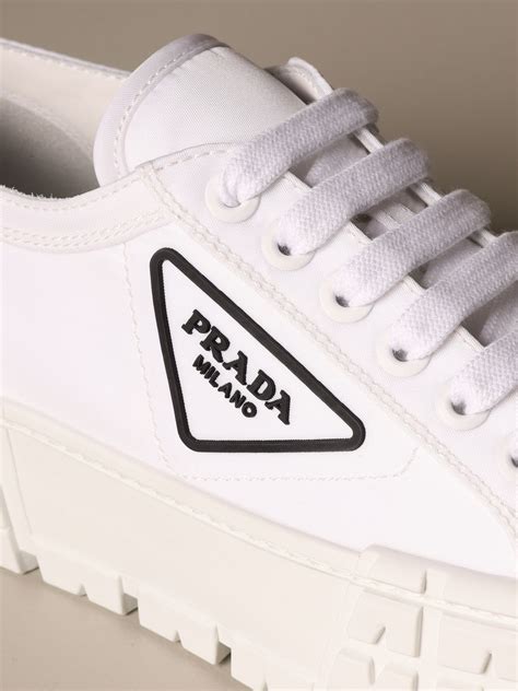 all white prada sneakers.